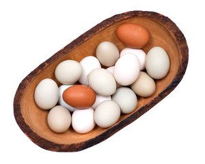 Unwashed fresh organic gmo and soy free pasture raised chicken eggs in wooden bowl isolated on white background