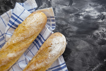 Sliced bread over dark stone table. View from above with copy space
