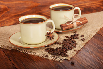 black sweet coffee in brown cups with vanilla cane and anise flower