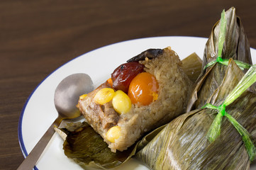 Ba jang (rice Dumpling) Zongzi Chinese food in white dish on brown wooden  background