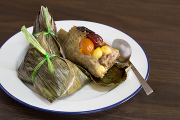 Ba jang (rice Dumpling) Zongzi Chinese food in white dish on gray wooden  background