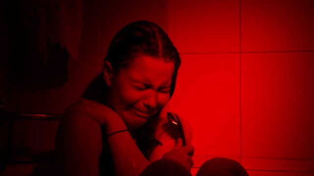 Crying young girl in shower. Depression, vilolence, abuse concept