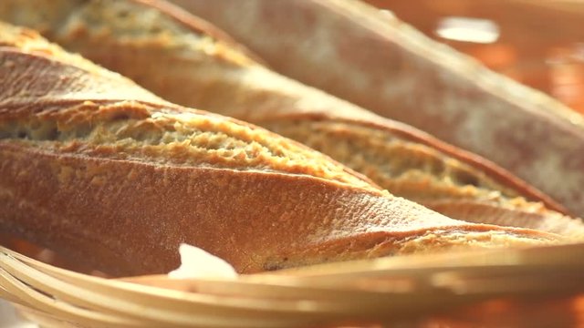 Bakery bread on a wooden table. Fresh bread and sheaf closeup. Slow motion. 4K UHD video footage. 3840X2160