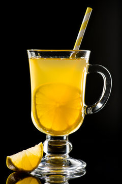 Hot grog with lemon and honey on dark background
