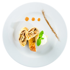 Apple strudel with nuts, raisins, cinnamon and powdered sugar Isolated on white background