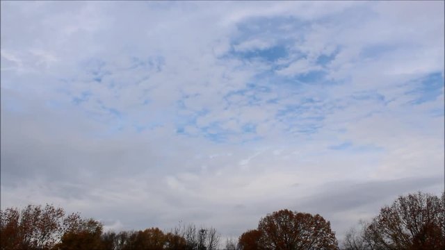 Time-Lapse clip of winter storm Dylan's Stratus Cloud Takeover of the South on Christmas weekend . Midday  stratus clouds racing across a ice blue sky background