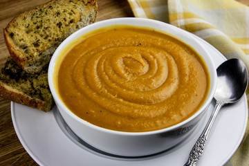 A bowl of homemade butternut squash soup and garlic bread