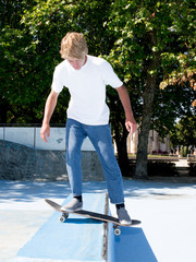 young caucasian skater on a high jump  at the skatepark