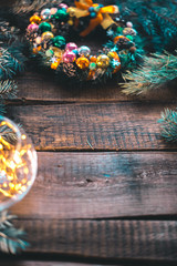 New Year's still-life. Christmas tree branches and ornaments on a wooden background