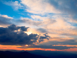 Cloudy colorful sunset over the heights of the mountains, Ceahlau, Romania