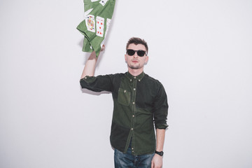 man wearing green shirt, sunglasses and holding green handkerchief