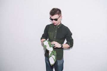 man wearing green shirt, sunglasses and holding green handkerchief