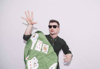 man wearing green shirt, sunglasses and holding green handkerchief