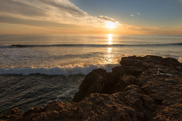 The calm sea in a very cloudy sunset