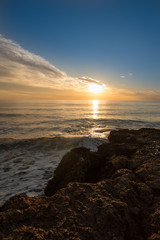 Fototapeta premium The calm sea in a very cloudy sunset