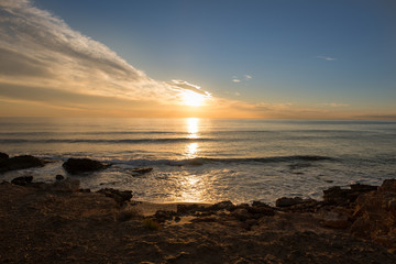 The calm sea in a very cloudy sunset