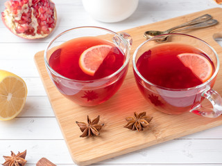 Hot homemade lemonade with pomegranate, lemon and winter spices