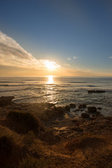 The calm sea in a very cloudy sunset
