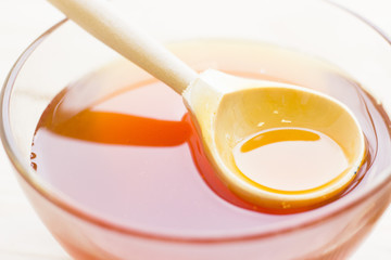 A bowl of honey with a spoon