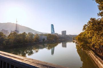 Obraz premium Panorama view of Tbilisi and Kura river. Modern landmark - Biltmore Hotel Tbilisi.