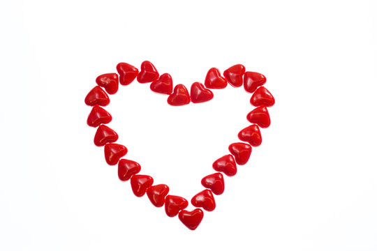 Valentines love concept: Red heart symbolize Love isolated on white background. Top view. Macro, close up.