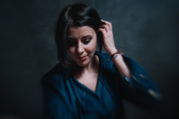 Beautiful brunete women portrait in studio on dark background