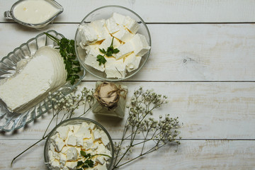 Dairy products on a wooden white background, top view.