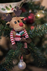 Christmas plush deer toy decoration. Christmas ornaments. Blurred background.
