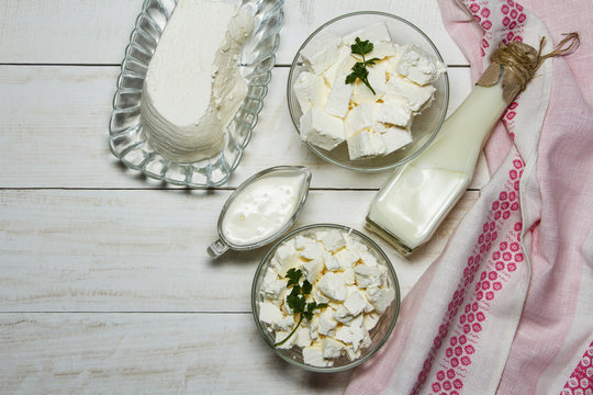 Dairy products on a wooden white background, top view.