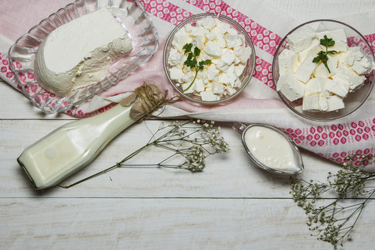 Dairy products on a wooden white background, top view.