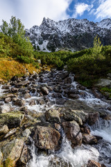 Obraz premium large Waterfall from ravine in autumn, long exposure with mountains in background