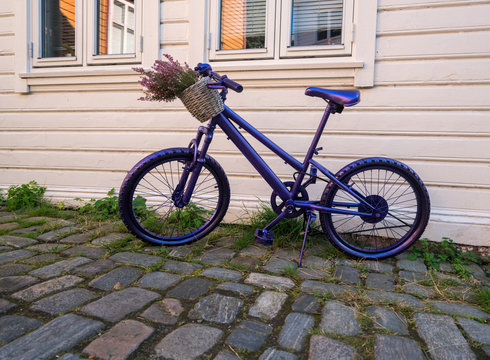 Purple bike in street in Bergen Norway