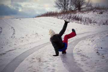 Slip on the slippery ice and snow on the road track at the country in freezing winter day.