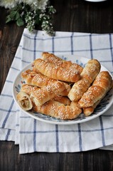 On a wooden table on a platter fresh bananas baked in a dough