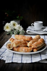 On a wooden table on a platter fresh bananas baked in a dough