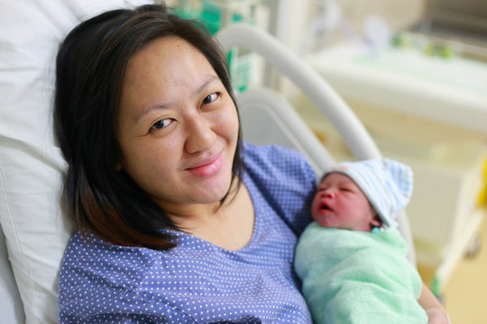 Mother holding her newborn child after labor