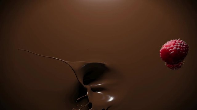 raspberries falling into melt chocolate