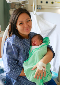 Mother holding her newborn child after labor