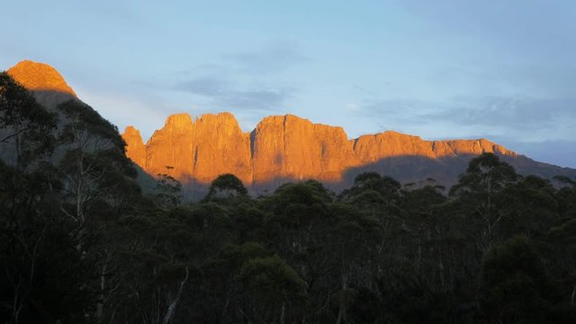 a panning shot of the acropolis and mt geryon as seen at sunrise from windy ridge hut in cradle mountain lake st clair national park, tasmania