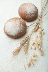 Fresh black bread, homemade cakes. Wheat ears on a white background, upright.
