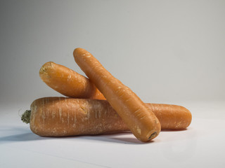 Three carrots on white background.