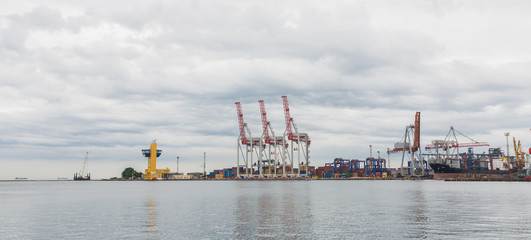 Obraz premium Lifting cargo cranes, ships and grain dryer in Sea Port of Odessa, Black Sea, Ukraine.