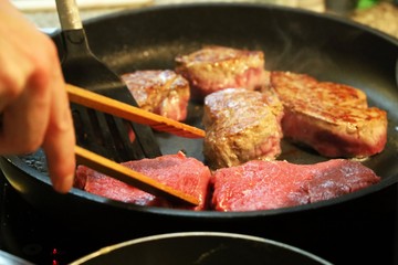 Beef fillet (beef tenderloin) grilling in the frying pan