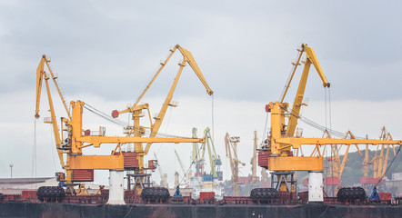 Lifting cargo cranes, ships and grain dryer in Sea Port of Odessa, Black Sea, Ukraine.