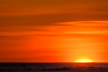 Vivid yellows, oranges, and reds of sunset over the frozen tundra of Hudson Bay, Manitoba, Canada
