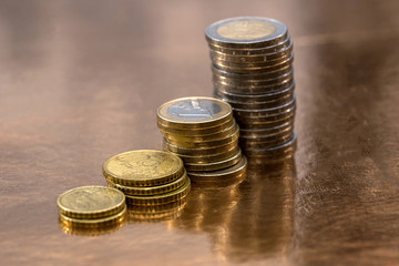a set of euro coins allocated on a golden background