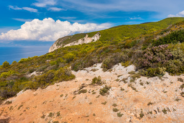 Rocks and dry grass on seaside cliff. Beautiful view of sea waters and coast on Zakynthos island Greece.