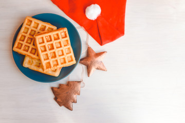 Top side view of delicious homemade waffles with a Christmas theme. Classic culinary styling close up overhead photography