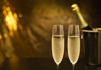 Champagne glasses on gold background. Vintage tone