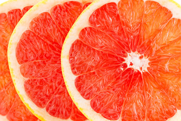 A fresh ripe juicy and appetizing grapefruit and its parts close-up, isolated on a white...